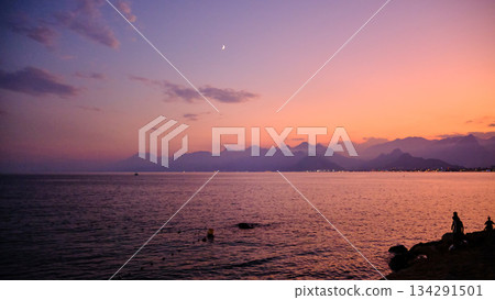 Sunset Coastline with Silhouetted Mountains 134291501