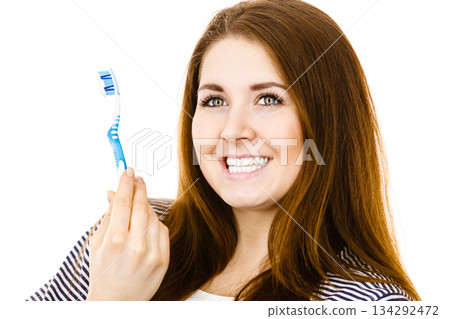 Woman holds toothbrush with paste. Woman holds toothbrush with paste. 134292472