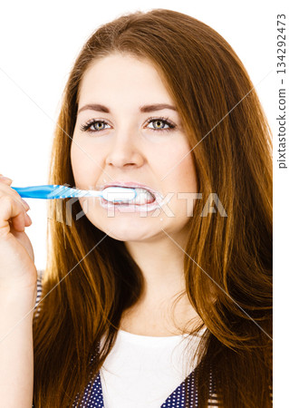 Woman brushing cleaning teeth. Woman brushing cleaning teeth. 134292473