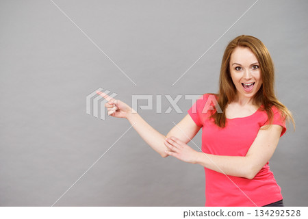 Woman pointing, surprised face expression 134292528