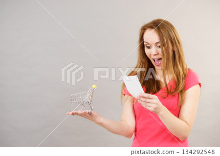 Woman with bill and shopping cart 134292548