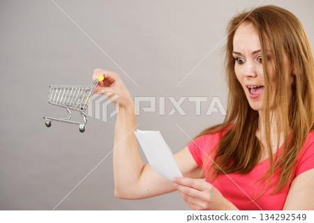 Woman with bill and shopping cart 134292549