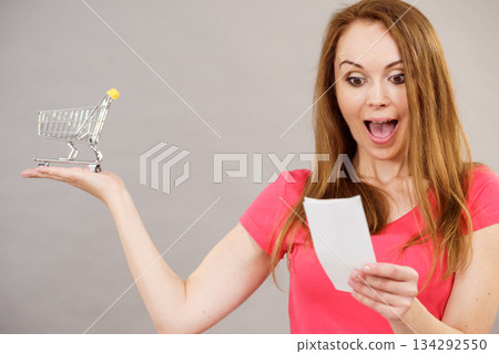 Woman with bill and shopping cart 134292550