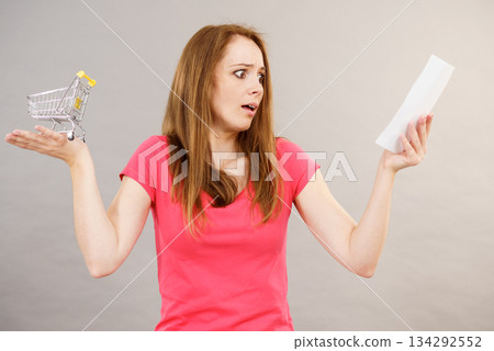 Woman with bill and shopping cart 134292552