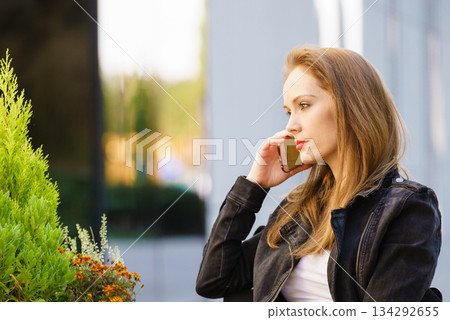 Fashion model in jeans jacket walking outdoor Fashion model in jeans jacket walking outdoor 134292655