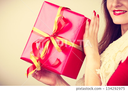 Woman with red christmas gift box Woman with red christmas gift box 134292975