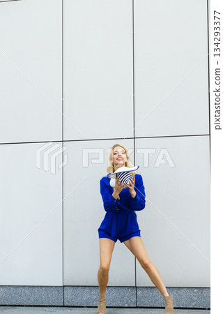 Fashion model playing with hat Fashion model playing with hat 134293377