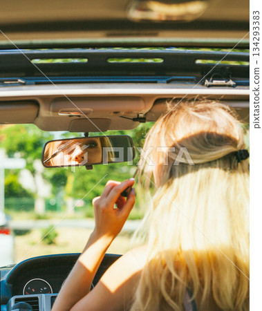 Girl apply make up while driving car. Girl apply make up while driving car. 134293383