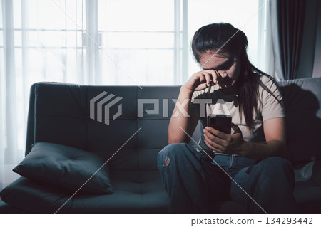 Sorrowful woman sat alone, overwhelmed by emotion, her sad and unhappy expression revealing deep despair, stress and distress left feeling depressed. sorrowful sad, despair alone, depressed stress 134293442