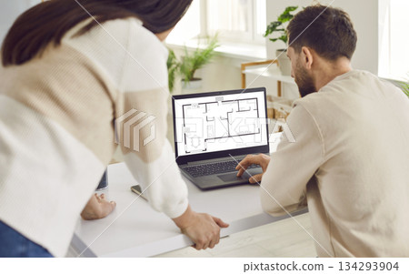 Two architects or interior designers working with design project of new apartment on a laptop. 134293904