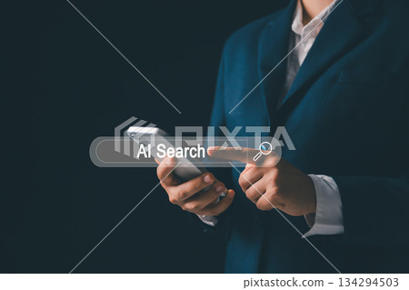 Person using smartphone, touching virtual AI search bar, representing artificial intelligence, digital search technology, mobile innovation, smart data interaction, modern online searching behavior. Person using smartphone, touching virtual AI search bar, representing artificial intelligence, digital search technology, mobile innovation, smart data interaction, modern online searching behavior. 134294503