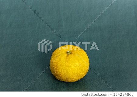 Yuzu placed in the center of a blue-green background. Winter solstice image, citrus material. 134294803