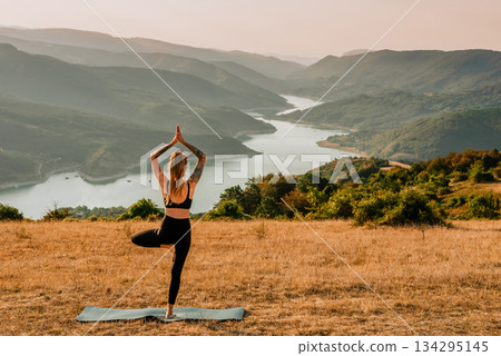 Yogi Woman Balancing in Tree Pose in Nature 134295145