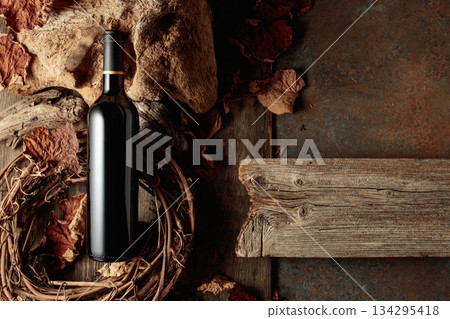 Bottle of red wine on a vintage rustic background. Bottle of red wine on a vintage rustic background. 134295418
