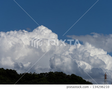 Cumulonimbus clouds rising over the mountains 134296210