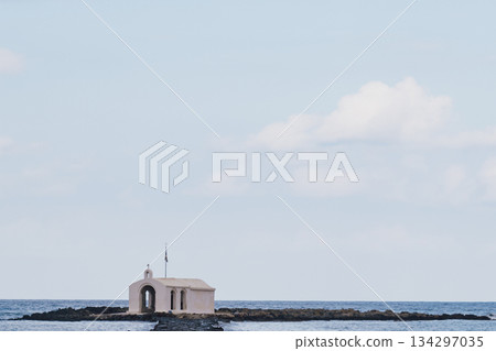 Coastal sentinel: the miniature stone church standing alone against the blue of the Mediterranean Coastal sentinel: the miniature stone church standing alone against the blue of the Mediterranean 134297035