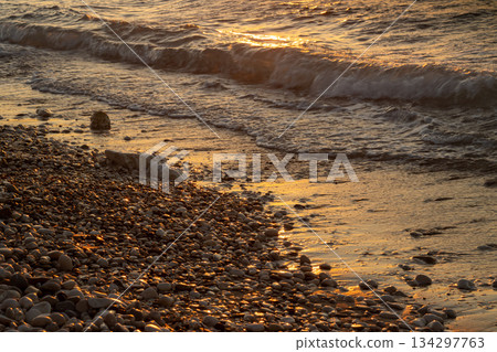 Pebbles and sea detail in the sunset, Greece Pebbles and sea detail in the sunset, Greece 134297763
