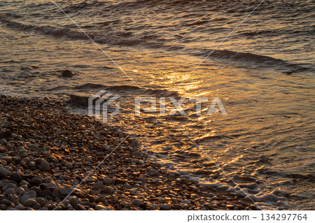 Pebbles and sea detail in the sunset, Greece Pebbles and sea detail in the sunset, Greece 134297764