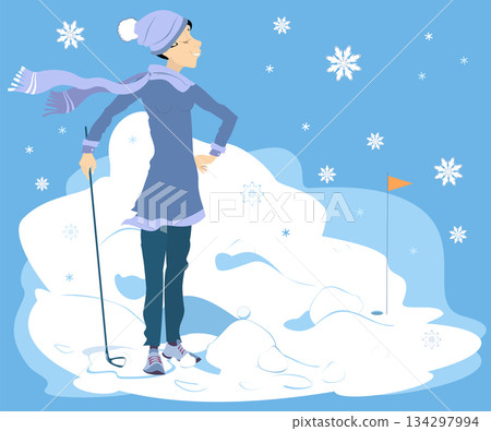 Winter. Golfer woman on the golf course.  Snow. Golf course. Cheerful golfer young woman with golf club aiming to do a good shot 134297994