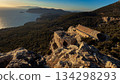 Ancient stone ruins overlooking a lush forest and the Aegean Sea 134298293