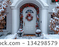 White door with wreath and red bow for Christmas 134298579