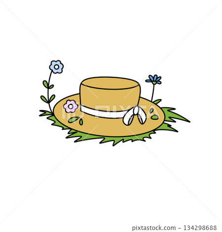 A yellow hat with flowers on it is sitting on the grass A yellow hat with flowers on it is sitting on the grass 134298688