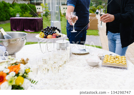 Outdoor Reception Table With Champagne Fruits And Candy Outdoor Reception Table With Champagne Fruits And Candy 134298747