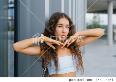 Trendy Teenager With Pouting Lips Outdoors Trendy Teenager With Pouting Lips Outdoors 134298761