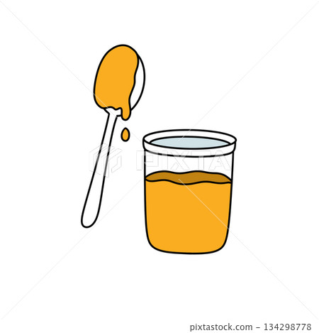 A spoon is in a glass of orange liquid 134298778
