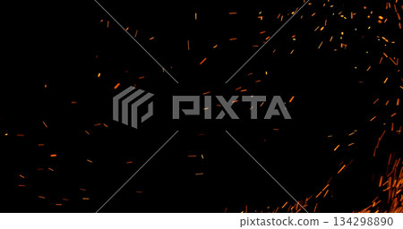Realistic fire sparks flying through the air, isolated on a black background. Perfect as a cinematic VFX overlay, fire particles effect or visual element. Realistic fire sparks flying through the air, isolated on a black background. Perfect as a cinematic VFX overlay, fire particles effect or visual element. 134298890