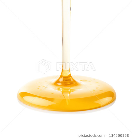Golden Honey Pouring Smoothly Onto a Surface, Showcasing Its Rich Texture and Color 134300338