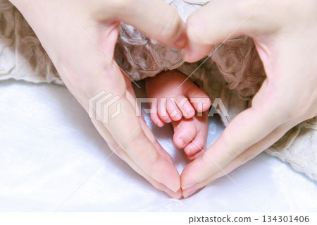 Newborn's foot and mama's hand Newborn's foot and mama's hand 134301406
