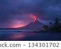 A volcano releases smoke and lava during sunset. Waves crash on the beach as dark clouds surround the scene. Palm trees stand nearby 134301702