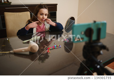 Girl With Face Mask Films Beauty Tutorial At Home Using Phone Camera Setup 134301735