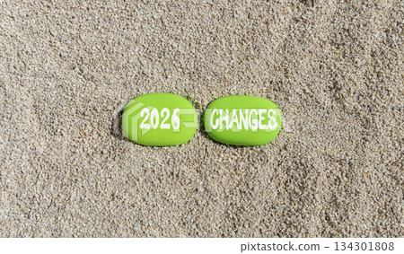 2026 Changes symbol. Concept words 2026 Changes on beautiful green stones on sand beach. Beautiful sand beach background. Business and 2026 changes concept. Copy space. 134301808