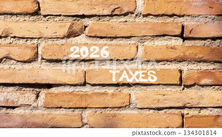2026 taxes new year symbol. Concept words 2026 taxes on beautiful brown brick wall. Beautiful brown brick wall background. Business and 2026 taxes new year concept. Copy space. 2026 taxes new year symbol. Concept words 2026 taxes on beautiful brown brick wall. Beautiful brown brick wall background. Business and 2026 taxes new year concept. Copy space. 134301814