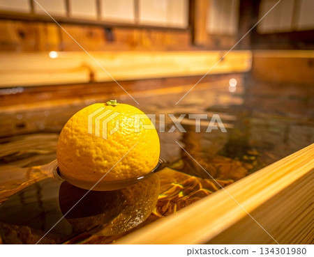 一顆柚子漂浮在柏木浴缸中，營造出日式冬至景象。 134301980