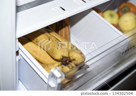 Ripe fruits in the refrigerator compartment. Fruits are in the fridge. 134302504