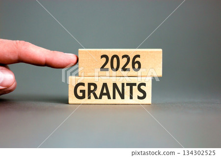 2026 Grants symbol. Concept words 2026 Grants on beautiful wooden blocks. Beautiful grey paper background. Businessman's hand. Business and 2026 grants concept. Copy space. 2026 Grants symbol. Concept words 2026 Grants on beautiful wooden blocks. Beautiful grey paper background. Businessman's hand. Business and 2026 grants concept. Copy space. 134302525