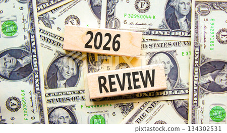 2026 Review symbol. Concept words 2026 Review on beautiful wooden blocks. Beautiful dollar bills background. Dollar bills. Business and 2026 review concept. Copy space. 134302531
