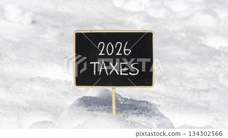 2026 taxes new year symbol. Concept words 2026 taxes on beautiful black blackboard. Beautiful white snow background. Business and 2026 taxes new year concept. Copy space. 2026 taxes new year symbol. Concept words 2026 taxes on beautiful black blackboard. Beautiful white snow background. Business and 2026 taxes new year concept. Copy space. 134302566