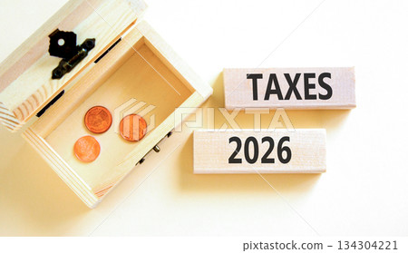 Taxes 2026 new year symbol. Concept words Taxes 2026 on beautiful wooden blocks. Beautiful white paper background. Beautiful wooden chest with coins. Business taxes 2026 new year concept. Copy space. Taxes 2026 new year symbol. Concept words Taxes 2026 on beautiful wooden blocks. Beautiful white paper background. Beautiful wooden chest with coins. Business taxes 2026 new year concept. Copy space. 134304221