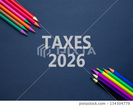 Taxes 2026 new year symbol. Concept words Taxes 2026 on beautiful black paper. Beautiful black paper background. Beautiful colored pencils. Business and taxes 2026 new year concept. Copy space. 134304779