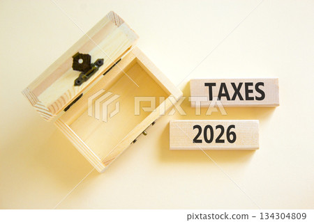 Taxes 2026 new year symbol. Concept words Taxes 2026 on beautiful wooden blocks. Beautiful white paper background. Beautiful empty wooden chest. Business and taxes 2026 new year concept. Copy space. Taxes 2026 new year symbol. Concept words Taxes 2026 on beautiful wooden blocks. Beautiful white paper background. Beautiful empty wooden chest. Business and taxes 2026 new year concept. Copy space. 134304809