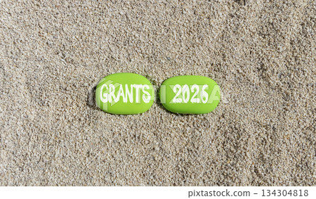 Grants 2026 symbol. Concept words Grants 2026 on beautiful green stones on sand beach. Beautiful sand beach background. Business and grants 2026 concept. Copy space. 134304818