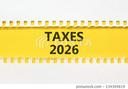 Taxes 2026 new year symbol. Concept words Taxes 2026 on beautiful yellow paper. Beautiful white paper background. Business and taxes 2026 new year concept. Copy space. 134304819