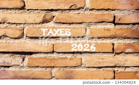 Taxes 2026 new year symbol. Concept words Taxes 2026 on beautiful brown brick wall. Beautiful brown brick wall background. Business and taxes 2026 new year concept. Copy space. Taxes 2026 new year symbol. Concept words Taxes 2026 on beautiful brown brick wall. Beautiful brown brick wall background. Business and taxes 2026 new year concept. Copy space. 134304824