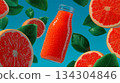 Visually appealing flat lay composition of a bottle of vibrant red grapefruit juice surrounded by sliced grapefruits and green leaves, against a blue background. Healthy food and drink. 134304846