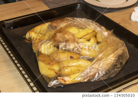 Potato wedges and chicken baked in plastic baking sleeve Potato wedges and chicken baked in plastic baking sleeve 134305010