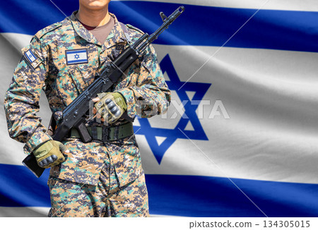 Israel flag with soldier holding assault rifle Israel flag with soldier holding assault rifle 134305015